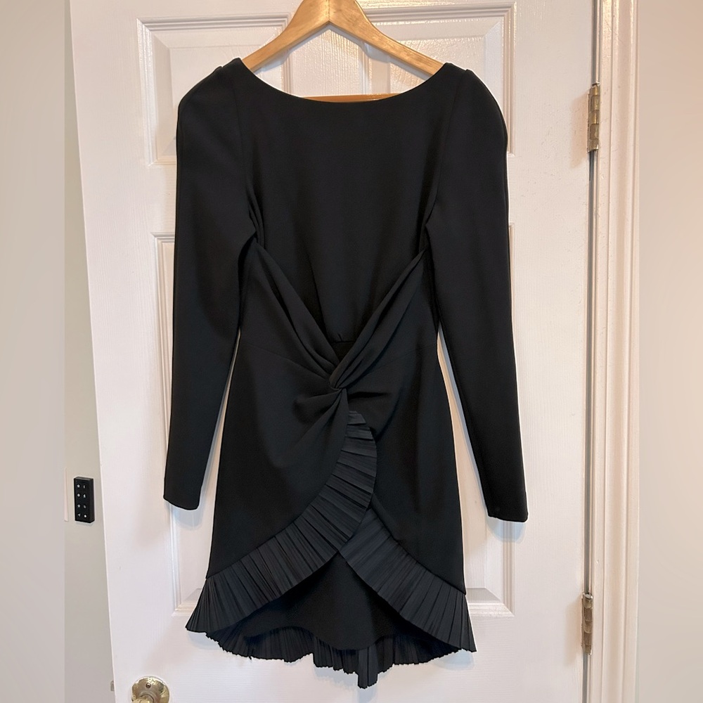 Black, open back, long sleeve dress. Brand is “One 33 Social”.